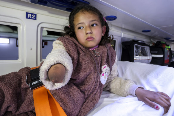 Palestinian Jori Abu Tueima, 7, injured in an Israeli ground and air offensive on Gaza, sits in an ambulance as the first group of Gaza children arrives in Jordan for medical treatment on Tuesday.