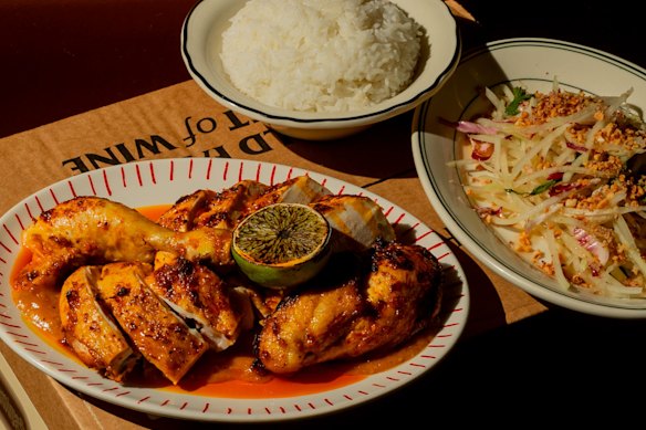 Wood-fired free-range chicken with burnt-chilli nuoc mam, papaya salad and steamed rice at Firebird in Prahran.