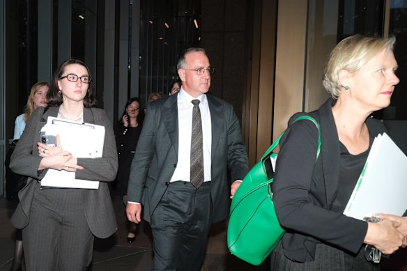 Woolworths’ former chief commercial officer Paul Harker (centre) leaving the Federal Court in Sydney.