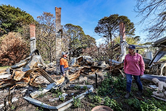 Rob and Bron Jamieson in the ruins of their farm homestead. Their house and farm were destroyed in the bushfires over the summer and now, they expect to be in a caravan for the next two years.