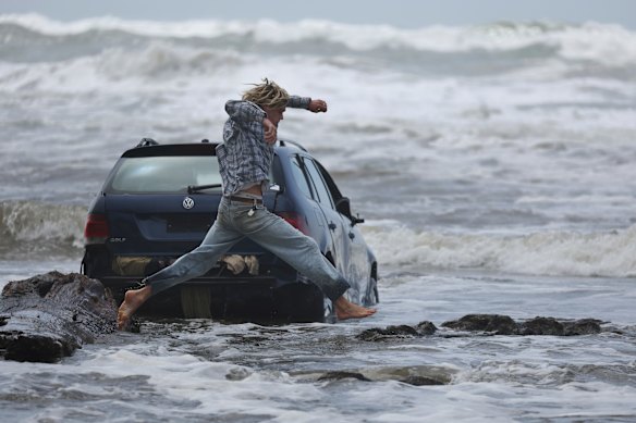 A local at Wye River, takes a look at a submerged car. Dealing with the clean-up after a ‘Tsunami’ like deluge of water swept through the town. 