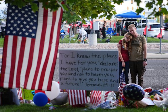 Christopher Bradford, right, and daughter, Neriah Bradford, pay their respects at a memorial for Charlie Kirk at Utah Valley University on Friday.