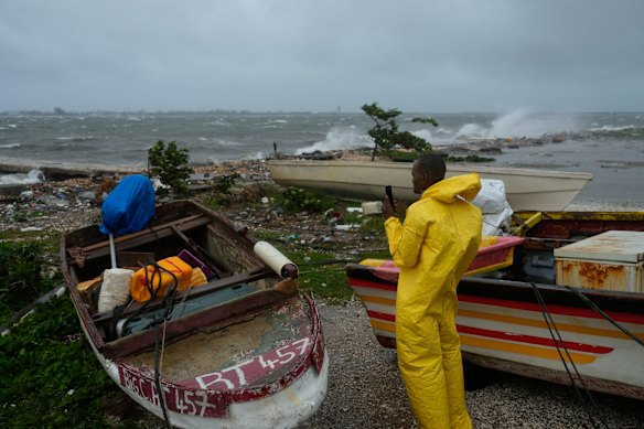 A man watches the coastline in Kingston, Jamaica, as Hurricane Melissa closes in.