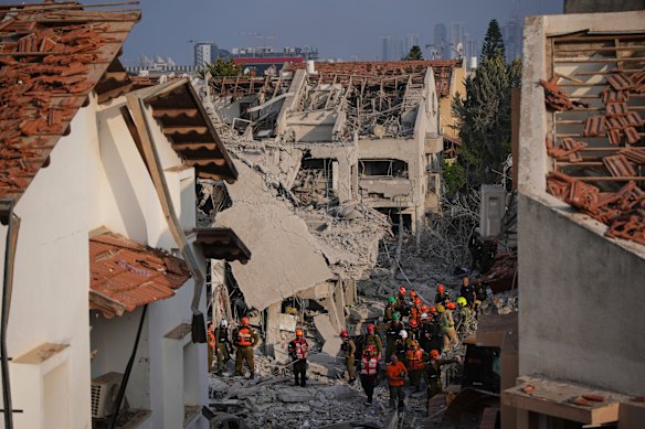 Israeli security forces inspect destroyed houses that were struck by a missile fired from Iran, in Rishon Lezion on Saturday.