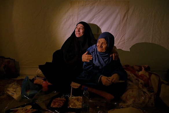 Zahra Issa with her mother, Um Ahmad, during Iftar inside their tent at the al Zarif Intermediate School. The school is now a shelter for more than 1000 displaced people in West Beirut who have fled Bint Jbeil in Southern Lebanon because of Israeli airstrikes.