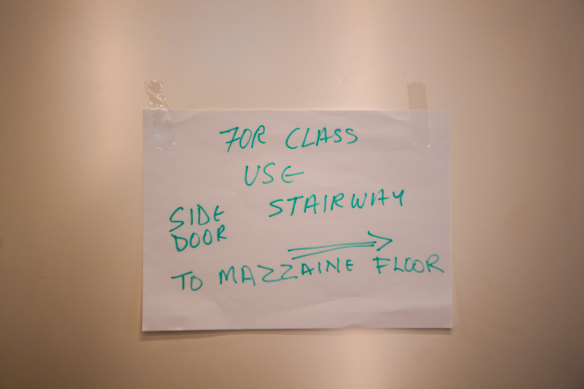 The handwritten sign in the foyer showing the way to AVETA college in Queen Street.