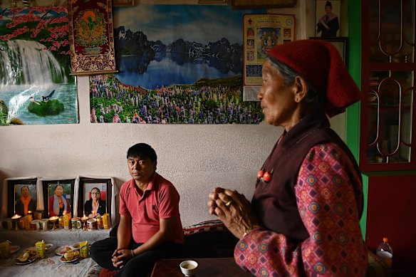 Chogyal Dorje Lama sits near photos of his wife, Pratima Tamang, who was a nurse and deputy mayor of the local council and was in an office building in Syabrubesi when the floods hit.