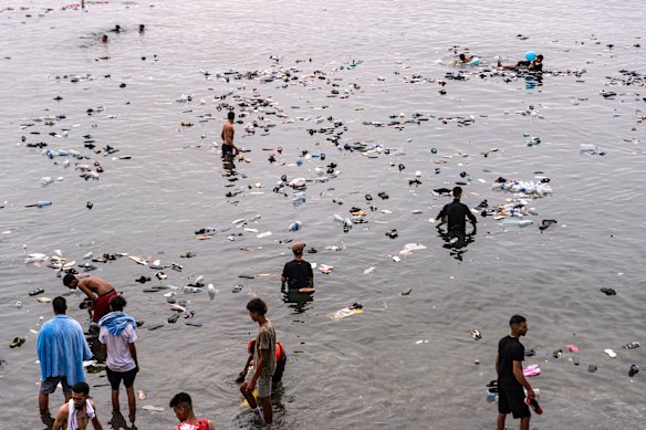 Belongings left behind by migrants float in the sea.