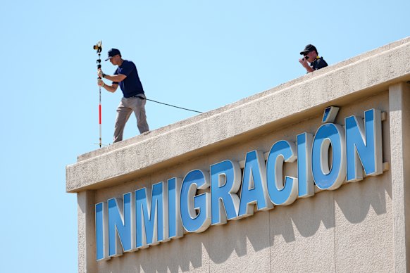 FBI agents investigate the crime scene near a U.S. Immigration and Customs Enforcement office in Dallas.