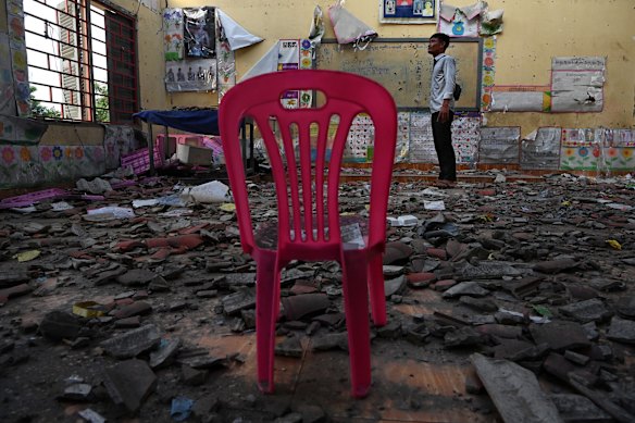 Ta Moan Sen Chey primary school teacher Srun Ngep inside a kindergarten classroom that was destroyed by Thai military bombing in July.