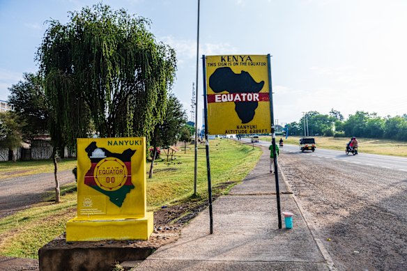 Signs marking the equatorial division between the northern and the southern hemispheres, Nanyuki, Kenya. 