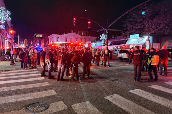 Police officers and first responders gather near the campus.
