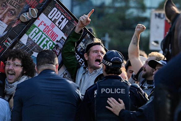 People protest against defence companies outside the Indo-Pacific 2025 International Maritime Exposition at Darling Harbour.