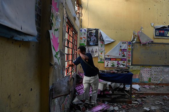Ta Moan Sen Chey primary school principal Lay Phalla takes in the kindergarten classroom that was destroyed by Thai military bombing.