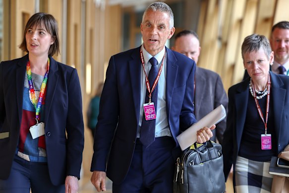Tim Davie, centre, has resigned as director-general of the BBC.