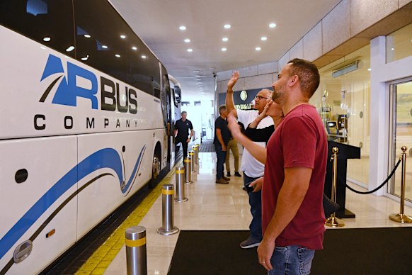 People wave goodbye to Australians being evacuated from Israel.