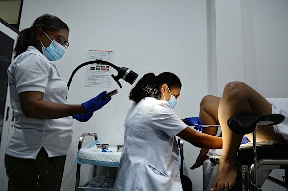 Dr Maria Jose GP (right) performs the thermal ablation treatment, assisted by midwife Filomena Mendonca Espirito Santo, at the Vera Cruz community health centre.