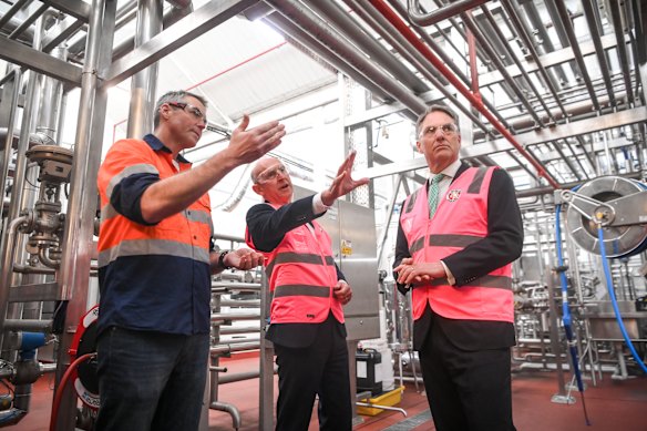 Little Creatures employee Miles Barraclough shows John Healey and Richard Marles around the Geelong brewery.