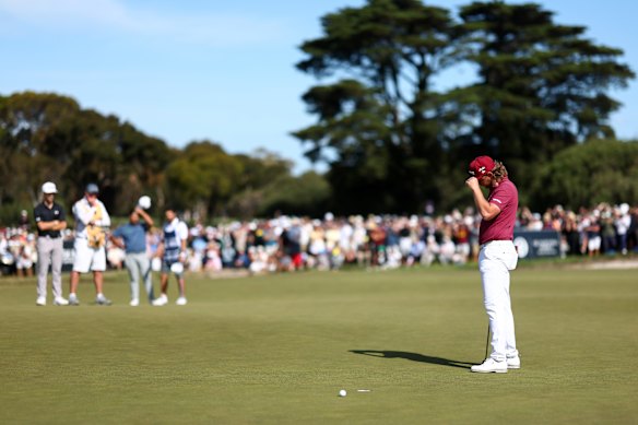 Cam Smith holds his head in his hands after missing a crucial putt on 18.