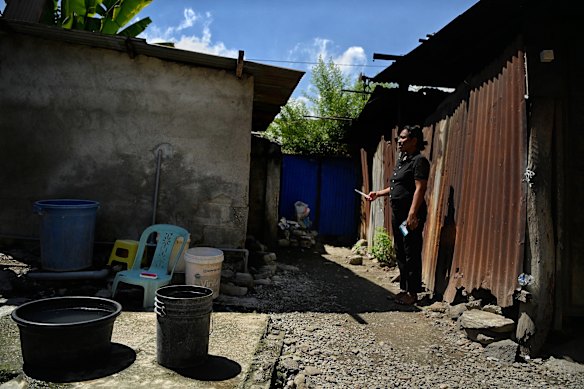 A Timorese woman waits to use the toilet to self-test for HPV at the outreach event.