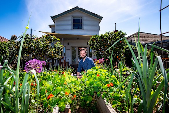 Tom Midwood in the backyard of his new home.