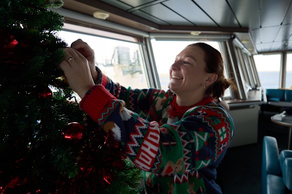 Madi Farrant sets up the Christmas tree on board the RSV Nuyina.  