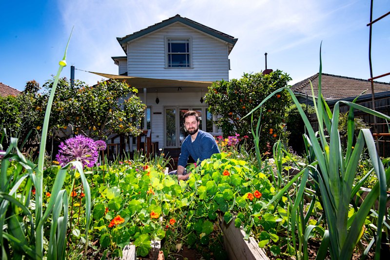 Tom Midwood in the backyard of his new home.