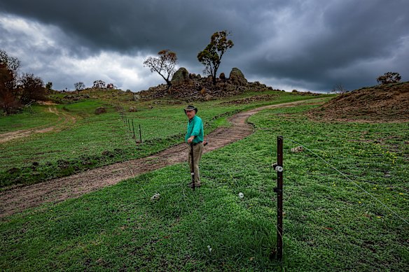 Michael Stubbe on his property, where a fence was cut for containment lines. Farmers and CFA volunteers are concerned that fences cut by the CFA for access during the Longwood fires have not been repaired two months on.