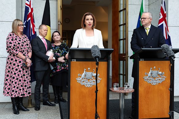 Parents Mia Bannister (left), Robb Evans and Emma Mason with Communications Minister Anika Wells and Anthony Albanese at a press at Parliament House in Canberra on Wednesday.