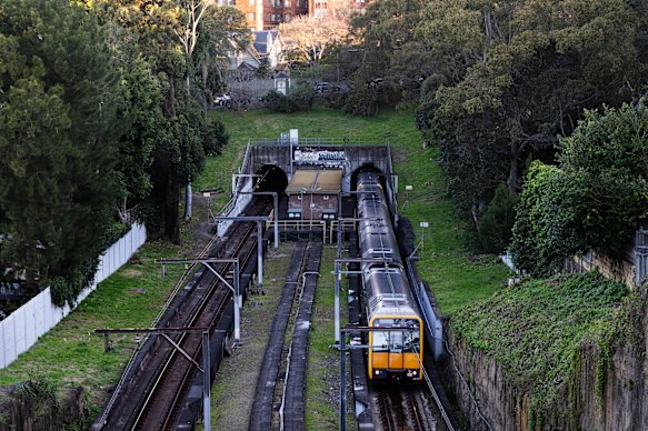 Trains pass through the abandoned Woollahra train station. 