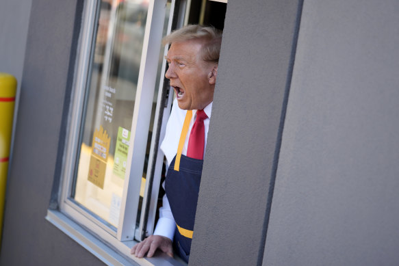 Donald Trump speaks while standing at a drive-thru window during a campaign stop at a McDonald’s.