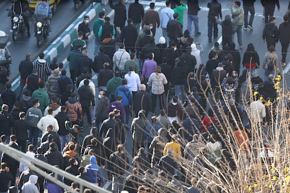 Protesters march in downtown Tehran on Monday.