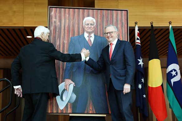 Bob Katter and Prime Minister Anthony Albanese shake hands in front of the former’s portrait.