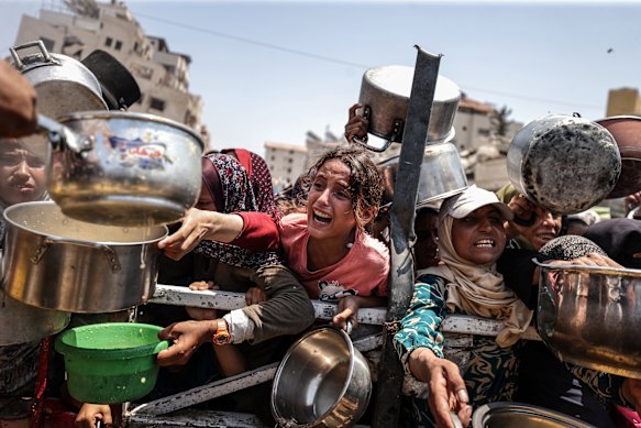 A charity distributes meals to Palestinians facing food shortages amid ongoing Israeli attacks and severe restrictions in Gaza on July 28.