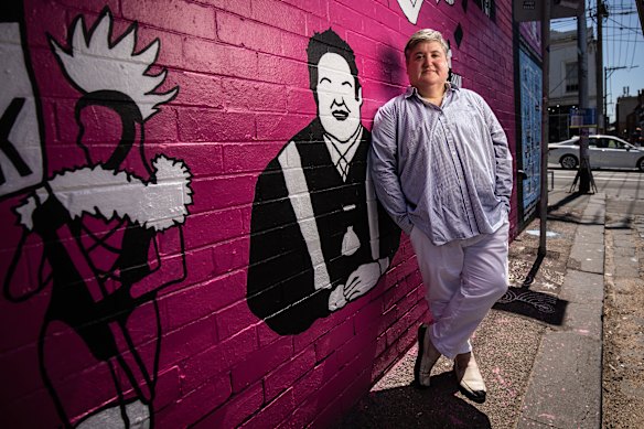 Briffa in 2022 alongside a mural painted in Fitzroy to celebrate Victoria’s LGBTQI+ history.