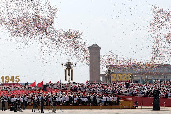 Balloons and doves are released into the air during the parade.