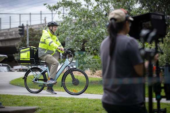 Jim Courier films an advertisement for Uber Eats cycling along the Yarra River. 
