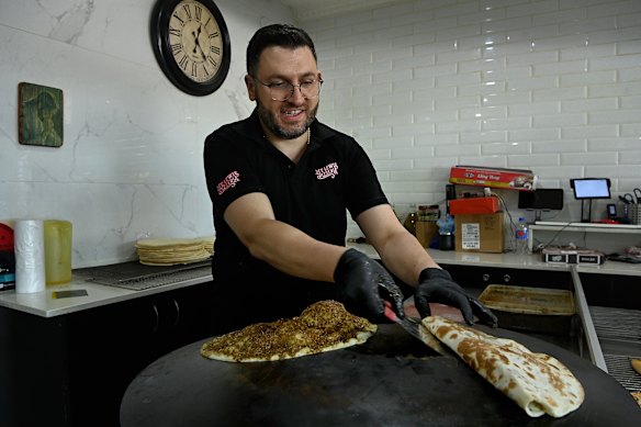 Mount Lewis Pizzeria manager Pierre Saba prepares a saj zatar, one of the most popular manoush they sell.