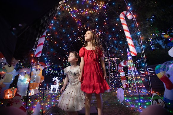 Pia (left) and Zadie Drmic admire their family’s Christmas lights.