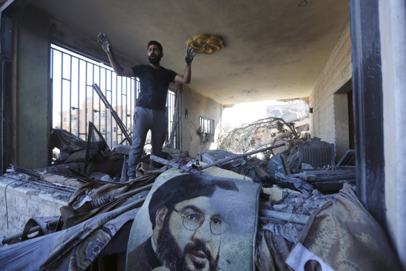 A man reacts in a damaged apartment at the site of an Israeli airstrike in Saksakieh, south Lebanon