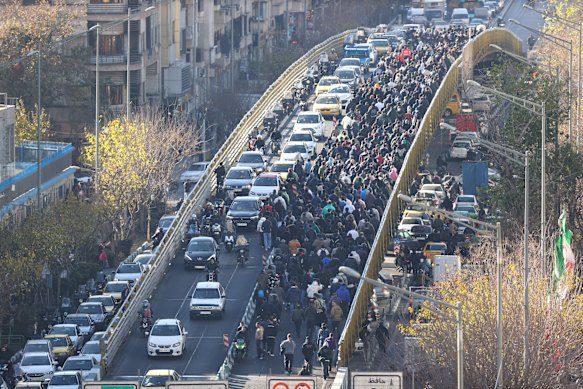 Protesters march in downtown Tehran on Monday.