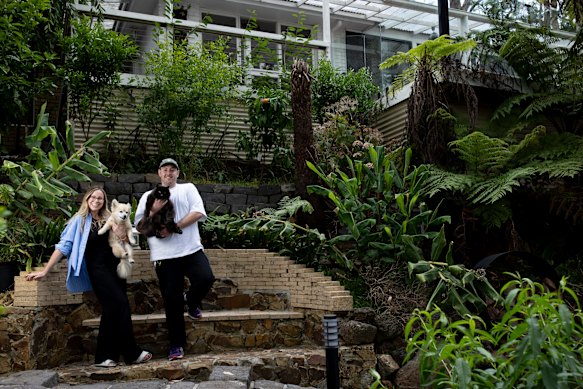 Christian Montti and Rhiannon Collins, with their dog Henry and cat Nudie, at their new home in Upwey.