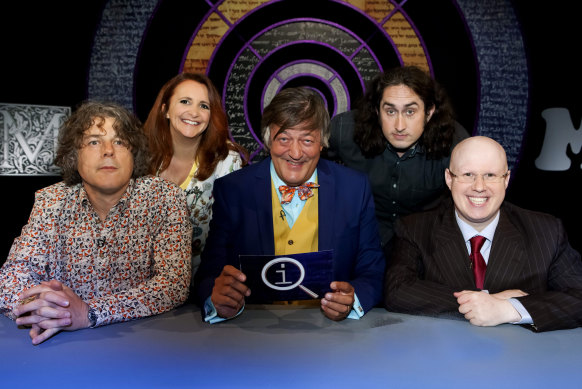 Stephen Fry (centre) connected  the acceptable   of the long-running QI.