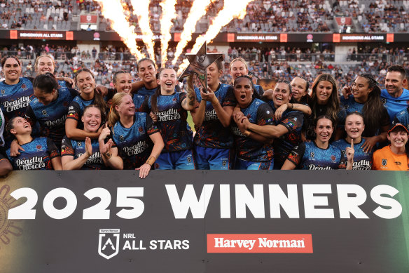 The women’s Indigenous All Stars lift the trophy.