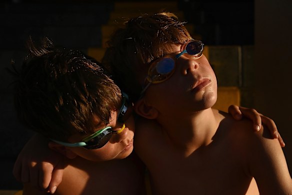 Brothers Maddox and Beckham Chapman in the moments before their morning swim at the Dubbo Aquatic Leisure Centre, taking advantage of the cool start to the day before temperatures reach 36 degrees. 