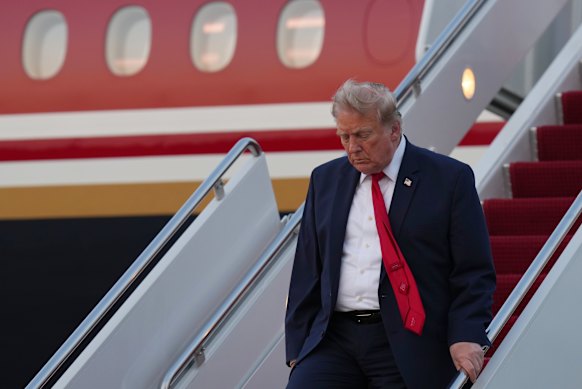 US President Donald Trump exits Air Force One on Sunday.