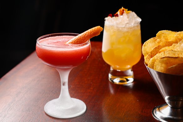 A Rhubarb Marg and Marigold Rush with a bowl of complimentary crisps.