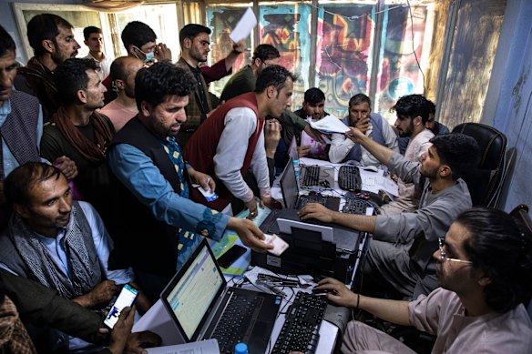 Special Immigrant Visa applicants crowd an internet cafe in Kabul to submit their forms two weeks before the US evacuated Afghanistan in August 2021.