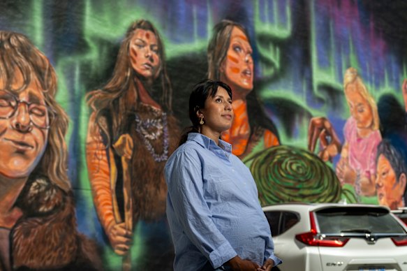 Wiradjuri artist Brandi Salmon, in front of a new mural she’s painted in Hobart, Tasmania, that’s a celebration of Palawa women.