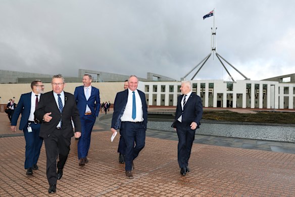 Coalition MPs led by Barnaby Joyce and Michael McCormack (right) walk to a press conference about energy policy on Monday.